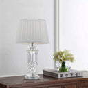 Luxury bedside lamp combining polished metal finishes, decorative glass, and a premium fabric shade for modern home décor.