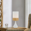 Compact designer table lamp placed on an entryway console, bringing understated elegance and functional accent lighting to the hallway.