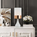 Modern white ceramic lamp paired with natural timber furniture, creating a fresh and inviting look for coastal-inspired interiors.