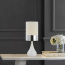 Decorative Akira Table Lamp illuminating a cosy reading corner with a premium fabric shade and soft diffused light.