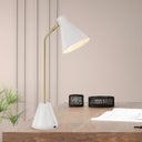 White Ambia desk lamp complementing a minimalist workspace with clean lines, compact proportions, and practical task lighting.