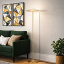 Elegant brass floor lamp placed beside an accent chair, delivering comfortable 3000K warm white lighting for reading and relaxation.