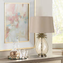 Elegant bedside lamp combining an antique chrome metal frame with a sculptural pineapple-shaped glass base for timeless luxury styling.