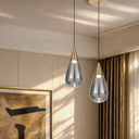 Designer single pendant with elegant champagne glass, integrated warm white LED, and minimalist styling for bedside, hallway, and café interiors.