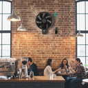Smart martec wall fan with oscillation for home and office People sitting at a counter in a coffee shop with a brick wall background from lightsandfansonline