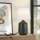 Traditional ceramic bedside lamp with a textured glazed base and classic white drum shade for cosy bedroom lighting.