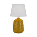 Butterscotch Baci Table Lamp adding warmth and character to a contemporary living room with its decorative ceramic finish and linen shade.