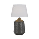 Grey ceramic table lamp styled on an entryway console, creating elegant ambient lighting with timeless handcrafted detailing.