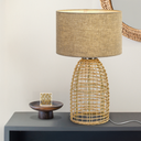 Modern coastal table lamp with a woven rattan base and neutral linen drum shade, perfect for Hamptons and Scandinavian interiors.