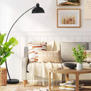 Heavy-duty iron floor lamp featuring a stable circular base and sculptural curved frame for stylish everyday lighting.