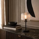 BOBO a Table lamp on a marble surface with books and a bowl in a room setting.