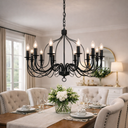  Candice 8-Light Candelabra Style Pendant Light  Black chandelier hanging above a dining table with floral centerpiece