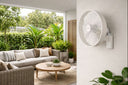 Como AC 16″ Wall Fan With Remote Control Wall fan with steel body and mounting bracket  in a outdoor living space with a wall-mounted fan, sofa, and plants.