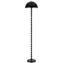 Estiq Floor Lamp positioned beside a contemporary lounge chair, featuring a sculptural twisted stem and glossy dome shade for modern ambient lighting.