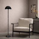 Luxury floor lamp styled in a boutique hotel suite, combining artistic form with functional accent lighting for sophisticated interiors.
