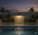 Martec MDA Epping Light Evening scene by a pool with plants and a wall light fixture from lights and fans online 