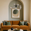 Contemporary glass globe pendant with black frame and amber tear glass shades for modern kitchen and dining areas.
