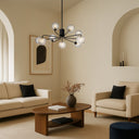 Decorative glass chandelier featuring smoke tear globes and modern black finish for luxury dining room décor.