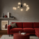 Contemporary designer pendant light with opal matt glass shades and warm antique gold frame for elegant interiors.