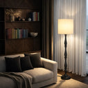 Traditional floor lamp styled in a cosy reading nook, providing comfortable illumination with a premium fabric drum shade and elegant silhouette.