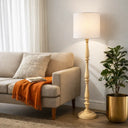 Farmhouse-inspired floor lamp placed beside a timber armchair, creating a welcoming atmosphere with warm ambient lighting and timeless design.