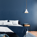 Ivy Designer Pendant – Vintage Porcelain White Modern bedroom with a blue wall, bed, and pendant light.