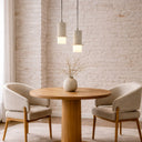 Luxury Kolisa pendant light showcasing a textured stone finish, adjustable cable suspension, and architectural lighting for boutique cafés and modern homes.
