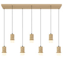Modern seven-light linear pendant featuring cast stone cylinders, integrated 3CCT LED technology, and elegant lighting for luxury dining rooms.