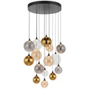Kupla 15-light cluster pendant featuring mixed smoke, champagne, and clear glass globes, creating a dramatic focal point in a luxury stairwell.