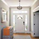 Lincon pendant light in a elegant Foyer with a white door, gray dresser, and mirror.