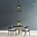 Lauren Designer Pendant Dining area with a round table, chairs, and decorative vases against a gray wall.