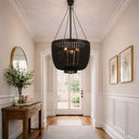 Maddisson Beaded Chandelier Collection Foyer with a black chandelier, wooden console table, and mirror.