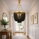 MADDISON_P3 in BLACK GOLD beaded chandelier hanging in a well-lit room with white walls and wooden floor.