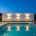 Martec Nova Tricolour LED Wall Light in a Pool area with illuminated wall at night from lights and fans online 