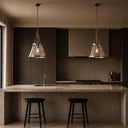 Industrial-style hanging light featuring a conical glass shade, adjustable chain mount, and warm ambient lighting for entryways and living spaces.