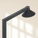 Modern LED floor light placed beside a sofa, offering adjustable brightness through a convenient touch dimmer for everyday comfort.
