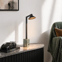 Satrom Green and black marble table lamp on a marble surface with a Lamborghini model car next to it, against a neutral wall.