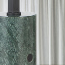 SATROM Green marble column with a black base against a white curtain background