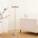 Luxury LED floor light placed beside a sofa, combining natural marble, premium metal finishes, and soft warm white illumination.