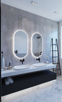 SO500C premium back-lit LED bathroom mirror with cool white lighting in a Modern bathroom with double vanity, illuminated mirrors, and a ladder against a concrete wall.