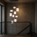 Torso 9 LED Pendant Light suspended above a staircase, showcasing a cascading designer pendant with warm 3000K LED illumination.