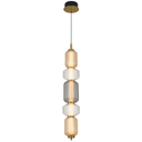 Torso 5 LED Pendant Light suspended above a kitchen island, showcasing elegant vertical pendant lighting with warm 3000K LED illumination.