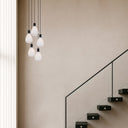 Tresor 5 Pendant Light featuring five mouth-blown opal matt glass shades with a modern black finish for elegant contemporary pendant lighting.