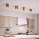 TORESS Small Aged Gold Leaf Surface Mount Light Modern kitchen with wooden cabinets, white countertops, and gold ceiling lights.