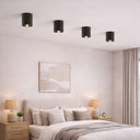 TORESS Small Charred Black Surface Mount Light in a Modern bedroom with a bed, nightstands, and wall art.