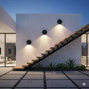 Martec Torino Tricolour LED Wall Light in a Modern house exterior with a staircase and wall lights at night from Lights and Fans Online .