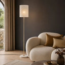 Modern statement floor light adding sophisticated accent lighting to an apartment interior with its laser-cut metal shade and refined architectural design.