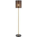 Valtor Floor Lamp standing beside a contemporary sofa, featuring a laser-cut cylindrical shade with antique gold accents for elegant ambient lighting.