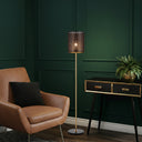 Mediterranean-inspired floor lamp enhancing a bohemian living space with elegant metal craftsmanship and decorative mood lighting.