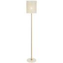 Modern floor lamp with a decorative perforated metal shade casting beautiful patterned light across a stylish living room wall.